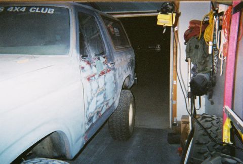 1983 Ford Bronco - 1983 Ford Bronco undergoing bodywork in a garage. Body shows primer and filler in preparation for paint.