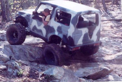 1989 Ford Bronco - A Suzuki Samurai navigates a challenging rocky terrain during an off-road excursion.