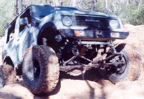 1989 Ford Bronco - Suzuki Samurai navigating rough terrain, showing its off-road capabilities.