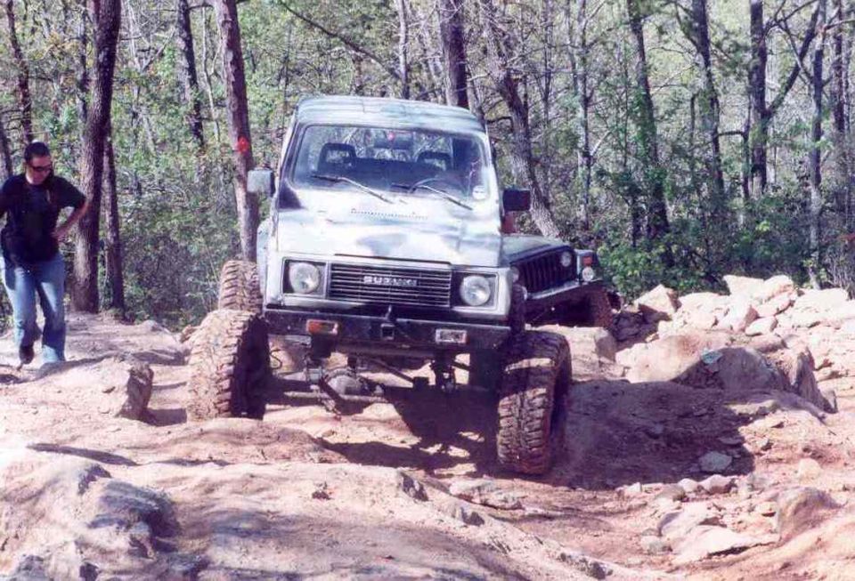 Suzuki Samurai off-roading on a rocky trail, front view