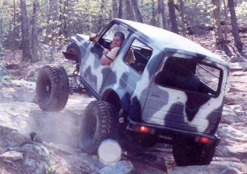 1989 Ford Bronco - This off-road vehicle navigates a rocky trail, demonstrating its climbing capabilities.
