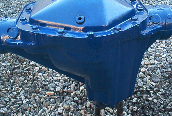Blue painted rear axle differential housing on gravel