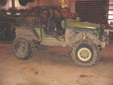 1992 Ford Bronco - This heavily modified SUV features a prominent roll cage and oversized tires, suggesting it's built for off-road performance.