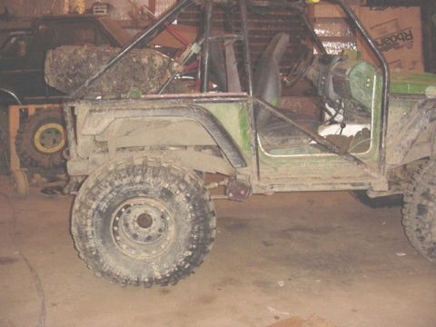 1992 Ford Bronco - This modified off-road vehicle features a prominent roll cage and large tires.