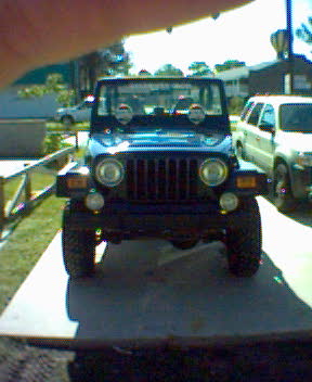 2002 Jeep Wrangler - 2002 Jeep Wrangler front view, parked in a residential area.
