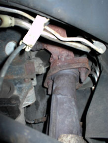1996 Ford Crown Victoria - Close-up of an exhaust manifold connection, with a Supermotors.net watermark.
