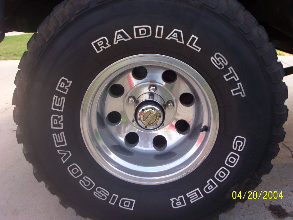 Close-up of Cooper Discoverer Radial STT tire on polished aluminum wheel with locking hub, dated 04/20/2004
