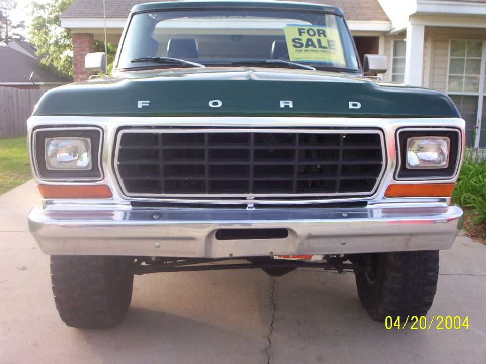 Front of green 1978-79 Ford truck with FORD grille letters, lifted, FOR SALE sign in window