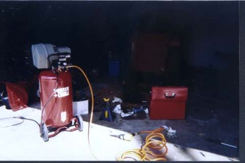 1996 Ford Bronco - Garage scene with an air compressor, red toolbox, and various tools on the floor.