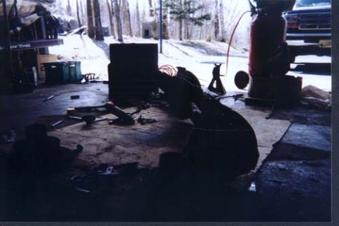 1996 Ford Bronco - A 1992 Ford Bronco is partially visible in a garage, surrounded by tools and parts.