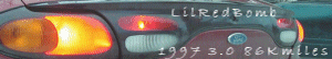 1997 Ford Taurus - Rear view of a 1997 Ford Taurus showing the illuminated taillight and trunk lid with mileage.