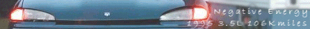 1997 Ford Taurus - The rear of a sedan is shown with illuminated taillights and visible text indicating the year, engine size, and mileage.