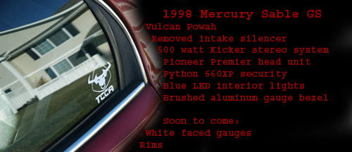 Red car door with a TCCA sticker and reflection of a house. Text lists 1998 Mercury Sable GS modifications