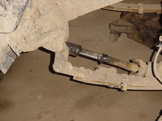 Close-up of rusty suspension linkage with a u-joint and tie rod end