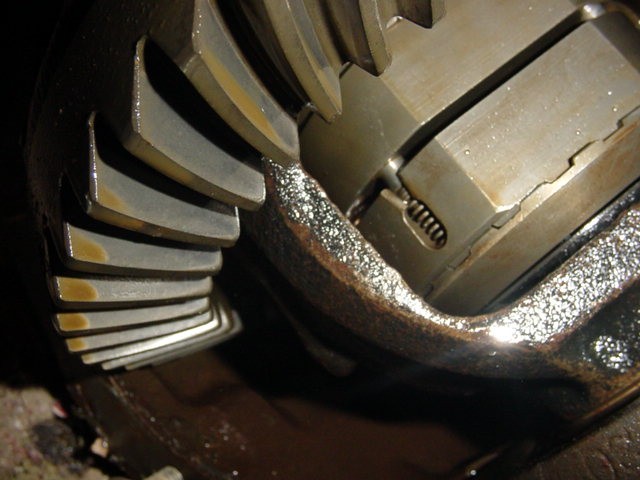 close-up of differential gears with oil on them, some wear visible on teeth