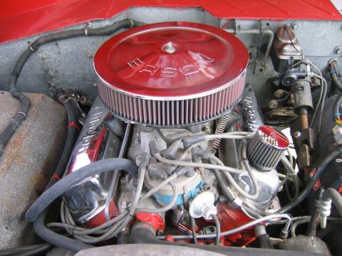 1969 Ford Bronco - Close-up view of a red engine bay chrome valve covers and a prominent red air cleaner.
