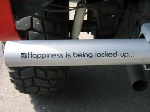 1969 Ford Bronco - Close-up of a vehicle's exhaust pipe a humorous sticker.