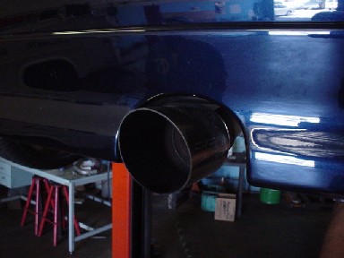 1993 Ford Taurus - A dark blue car's exhaust pipe is shown from the rear, with a "SUPERMOTORS" watermark at the bottom.