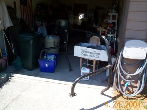 1992 Ford Bronco - Various metal parts, possibly for a roll bar installation, are visible in a garage setting alongside household items.