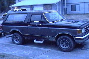 1989 Ford Bronco - This 1989 Ford Bronco is parked on a paved surface in front of a building.