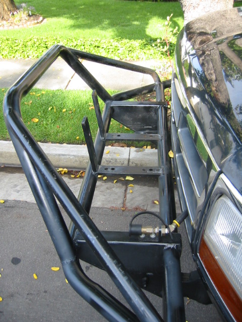 1992 Ford Bronco - A custom-fabricated brush guard is mounted to the front of a vehicle, obscuring the original bumper.