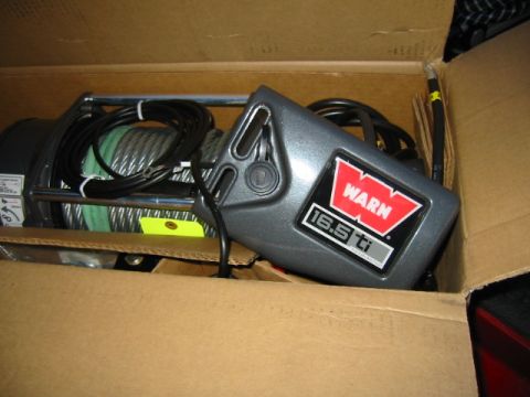 1992 Ford Bronco - A Warn 16.5ti winch, a powerful recovery tool, is shown packaged in its original cardboard box.