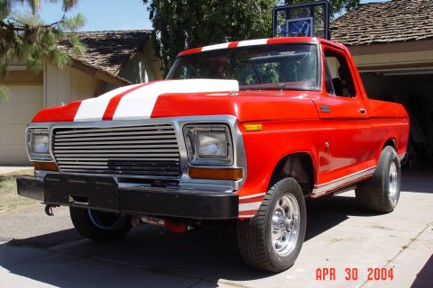1979 Ford Bronco - This red pickup truck has a custom paint job with racing stripes and chrome accents.