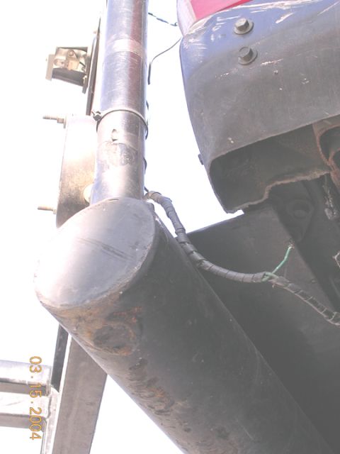 1994 Ford Bronco - Close-up view of a vehicle's rear bumper and exhaust pipe, with a date stamp of 03.15.2004.