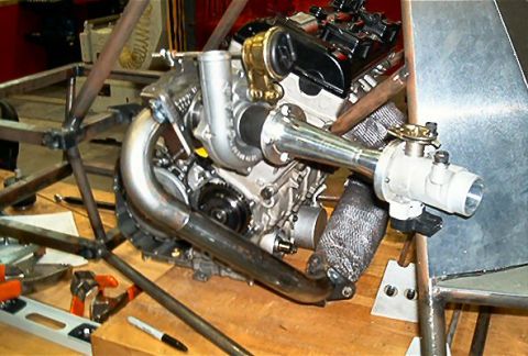 1985 Ford LTD Crown Victoria - Custom turbocharged engine assembly with exhaust and intake components, likely for a project car.