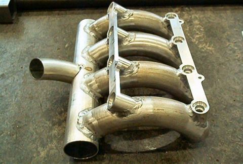 1985 Ford LTD Crown Victoria - A custom-fabricated aluminum intake manifold is shown from a three-quarter front angle.