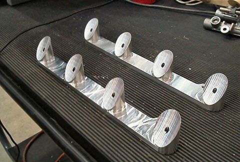 1985 Ford LTD Crown Victoria - Two custom metal brackets with angled posts are shown on a workbench.