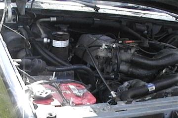 1989 Ford Bronco - The engine bay of a vehicle is shown, with a watermark from SuperMotors visible in the lower right corner.