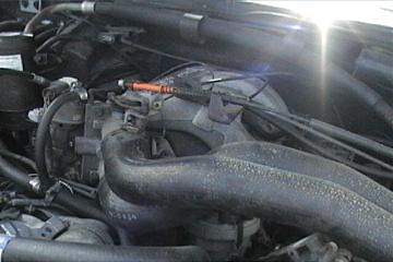 1989 Ford Bronco - Close-up view of the engine compartment, showing various components and hoses.