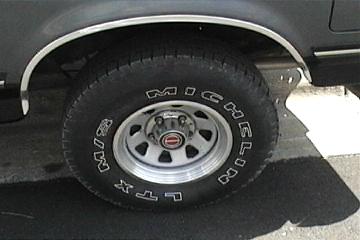 1989 Ford Bronco - This photo shows a close-up of a tire and wheel on a Ford Bronco, with visible text on the tire.
