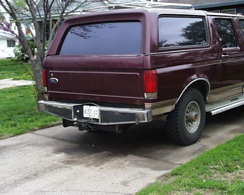1988 Ford C-350 (Centurion Conversions) - This maroon SUV, likely a 1987 model based on its body style, is shown from the rear with an aftermarket bumper and a visible license plate.
