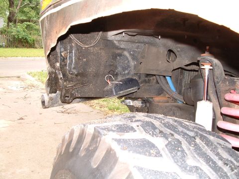 1979 Ford Bronco - Detail shot of the suspension and tire well of an off-road vehicle.