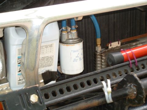1979 Ford Bronco - Transmission fluid filter and cooler lines are visible, along with a jug of fluid.