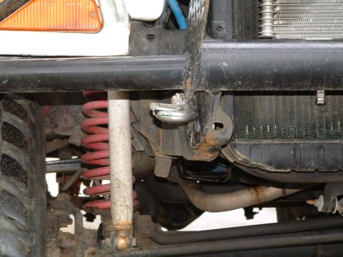 1979 Ford Bronco - Close-up of off-road vehicle's front suspension, shock, and bumper assembly.