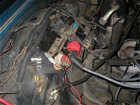 1987 Ford Crown Victoria LTD - Close-up view of engine bay components, including the ignition coil and various wires.