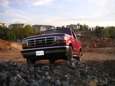 1994 Ford Bronco - This 1994 Ford Bronco navigates a rocky path under a partly cloudy sky.