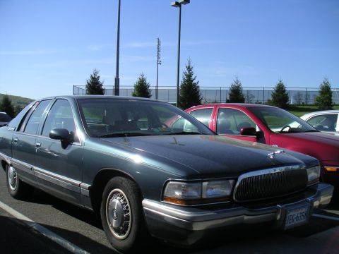 1994 Ford Bronco - This 1994 Buick Roadmaster sedan is parked next to a red car in a lot.