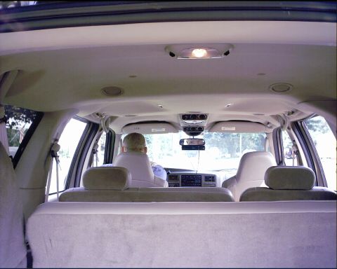 2003 Ford Excursion - View from the back seats of a 2003 Ford Excursion, showing the dashboard and driver.