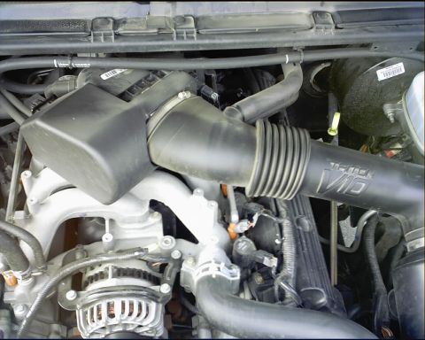 2003 Ford Excursion - Close-up view of the engine bay in a 2003 Ford Excursion, highlighting the Triton V10 air intake system.
