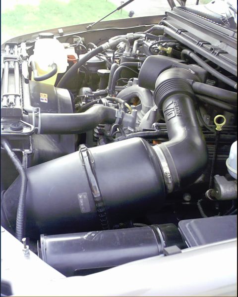 2003 Ford Excursion - Engine bay photo showing the V10 engine and air intake system.