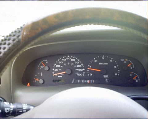 2003 Ford Excursion - The vehicle's interior shows the dashboard with a speedometer, tachometer, and other gauges.
