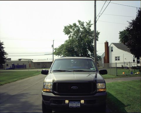 2003 Ford Excursion - This Ford Excursion is parked in front of a suburban house on a sunny day.