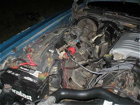 1987 Ford Crown Victoria LTD - Close-up view of a vehicle's engine bay, a Duralast battery and a Supermotors watermark.