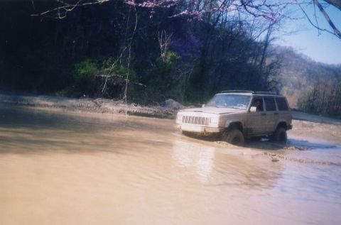 1991 Ford Bronco - Lucus's co-pilot, Daniel, pilots Lucus's Cherokee through standing water on one of the "gravel" access roads