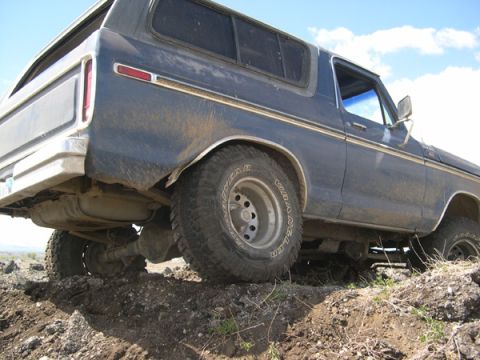 1978 Ford Bronco - This 1978 Ford Bronco is shown from the rear quarter angle, driving over rough terrain.