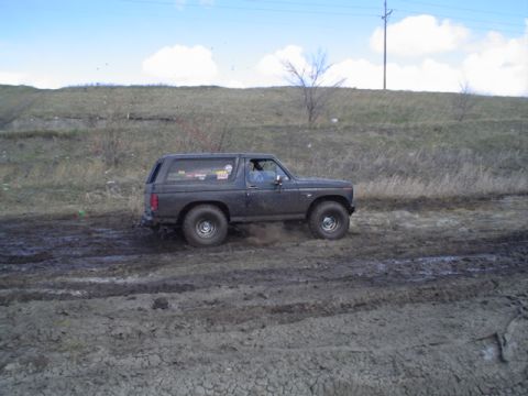 1981 Ford Bronco - This 1980 Ford Bronco navigates a muddy off-road course, kicking up dirt as it goes.